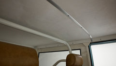 Interior ceiling and roll bar of Classic Ford Bronco with tan upholstery