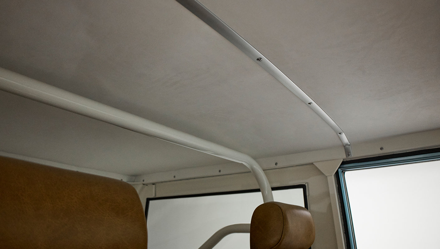 Interior ceiling and roll bar of Classic Ford Bronco with tan upholstery
