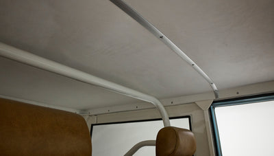 Interior ceiling and roll bar of Classic Ford Bronco with tan upholstery