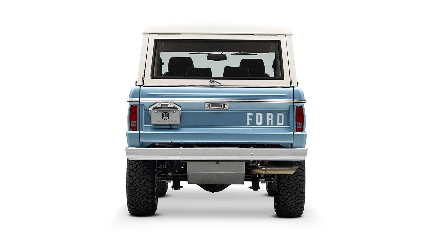 Rear view of Classic Ford Bronco Brittany Blue with white hardtop and FORD lettering on tailgate