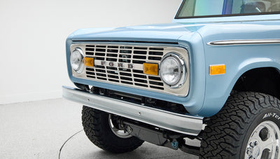 Front grille close-up of Classic Ford Bronco featuring round headlights and Ford emblem