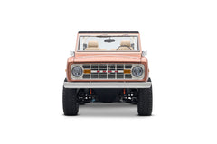 Front view of Classic Ford Bronco in peach color with beige seats and a white roll cage