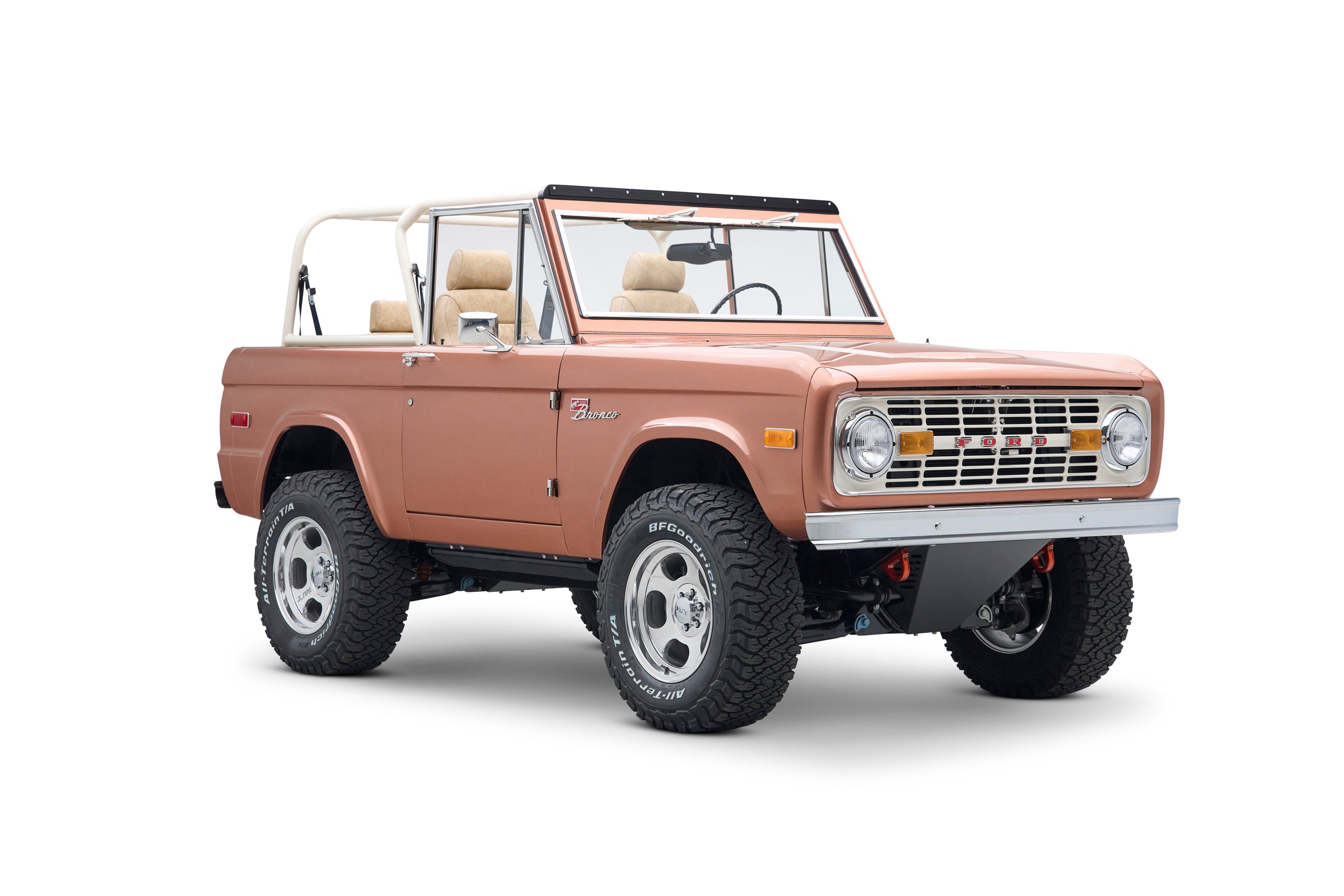 Front side angle of Classic Ford Bronco with off-road tires and beige seats visible