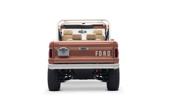 Rear view of Classic Ford Bronco in peach color with FORD lettering on the tailgate