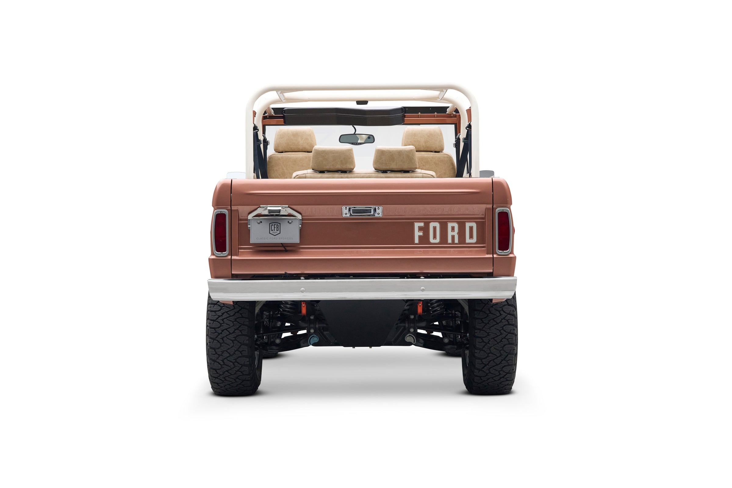 Rear view of Classic Ford Bronco in peach color with FORD lettering on the tailgate