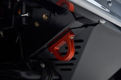 Red metal component mounted under the vehicle, part of Classic Ford Bronco's suspension or chassis