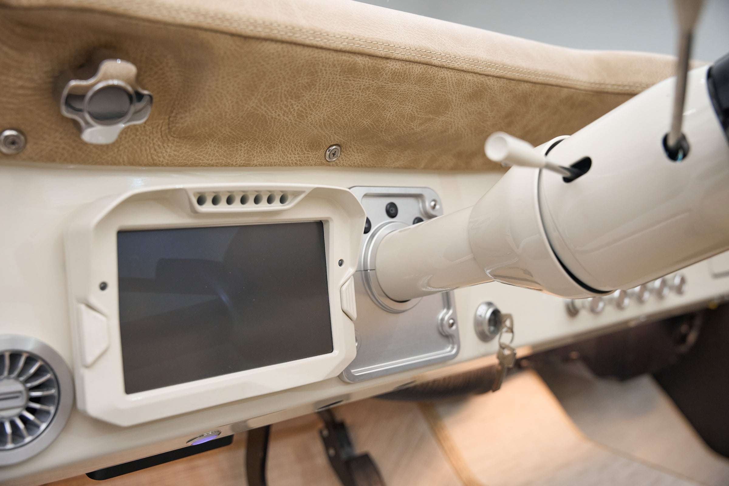 Dashboard of a Classic Ford Bronco featuring a digital screen and white steering column.