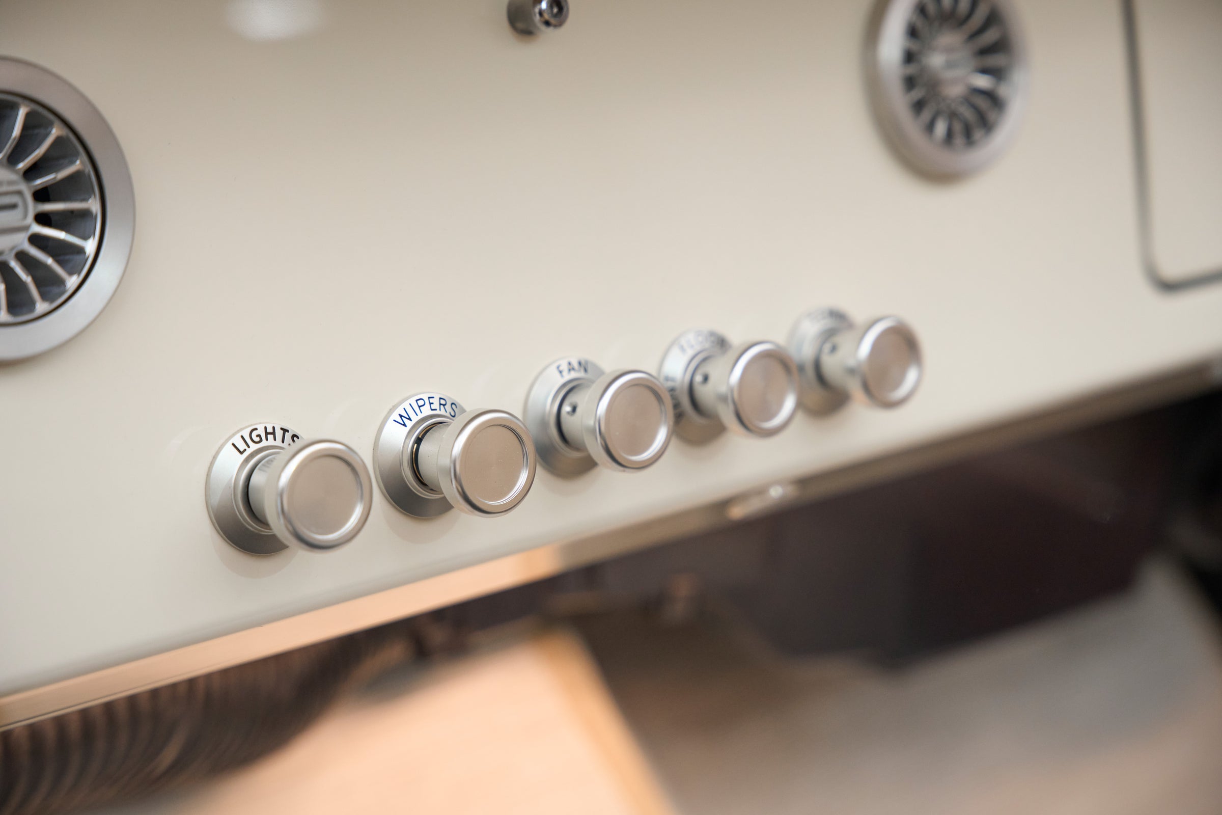 Close-up of vintage control knobs on the dashboard of a Classic Ford Bronco.