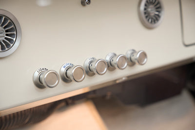 Close-up of vintage control knobs on the dashboard of a Classic Ford Bronco.