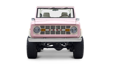 Front view of Classic Ford Bronco in pink with white trim and silver bumper