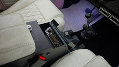 Close-up of beige leather seat and center console with Kenwood stereo in Classic Ford Bronco
