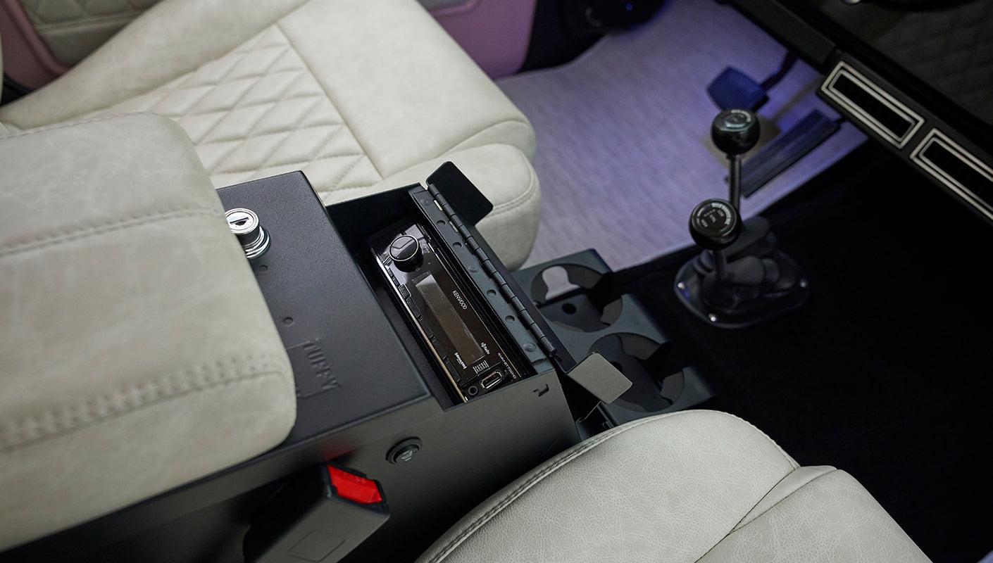 Close-up of beige leather seat and center console with Kenwood stereo in Classic Ford Bronco