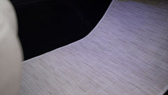 Light gray textured floor mat inside Classic Ford Bronco near front seats