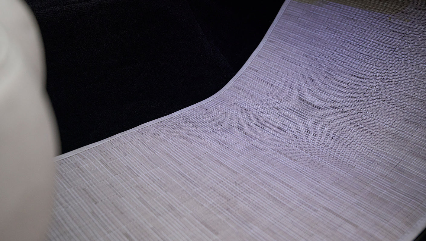 Light gray textured floor mat inside Classic Ford Bronco near front seats