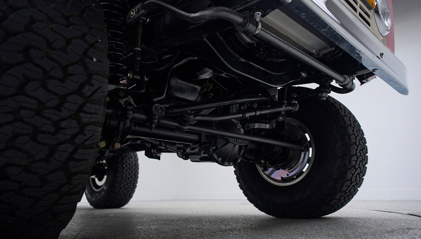 Undercarriage view showing suspension and tires of Classic Ford Bronco