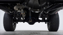 Underneath view of rear axle and differential of Classic Ford Bronco with tires visible