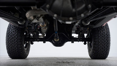 Underneath view of rear axle and differential of Classic Ford Bronco with tires visible