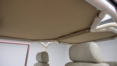 View of beige fabric roof frame and upholstery inside pink Classic Ford Bronco
