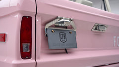 Close-up of pink Classic Ford Bronco rear showing taillight and license plate with CFB Series logo.