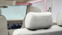 Cream-colored headrest inside a Classic Ford Bronco, visible through the open driver door.