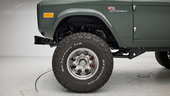 Close-up of Classic Ford Bronco rear left tire with BFGoodrich All-Terrain T/A lettering.