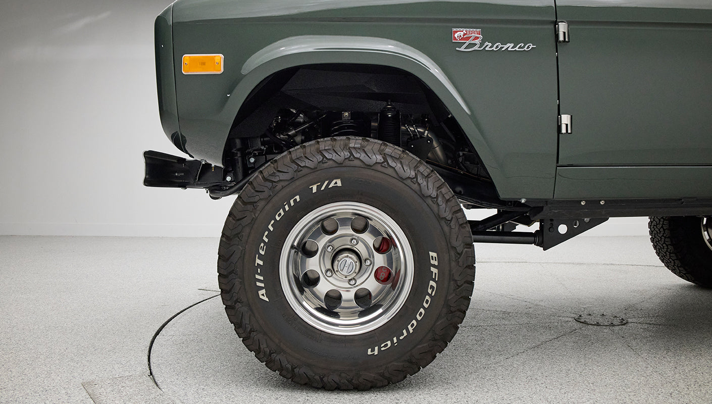 Close-up of Classic Ford Bronco rear left tire with BFGoodrich All-Terrain T/A lettering.