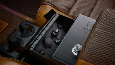 Open center console in Classic Ford Bronco showing USB ports, switches, and lockable storage