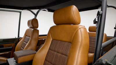 Close-up of Classic Ford Bronco front passenger seat and partial view of rear seat with brown upholstery