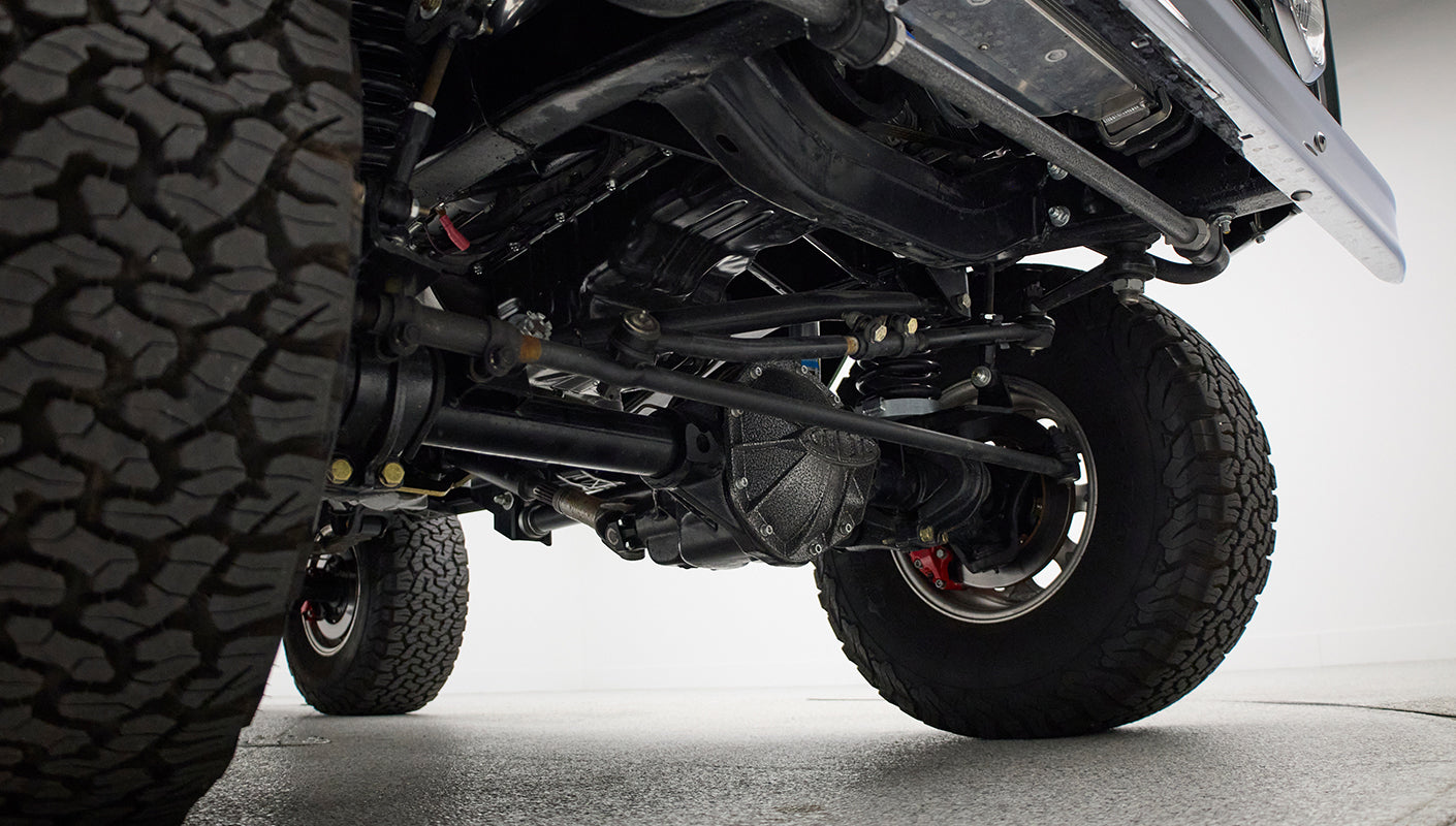 Undercarriage and front suspension components visible under Classic Ford Bronco