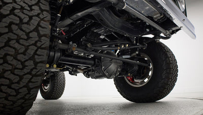 Undercarriage and front suspension components visible under Classic Ford Bronco