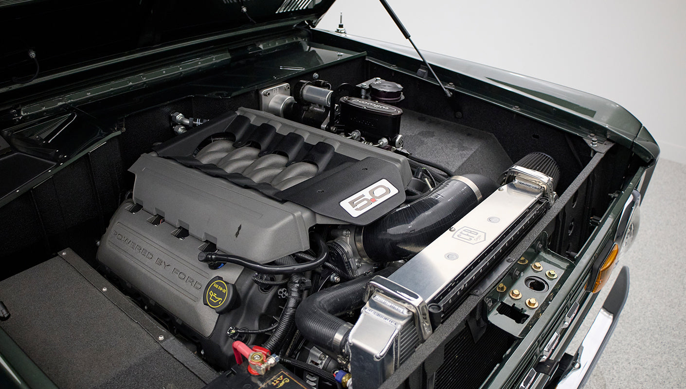 Engine bay of Classic Ford Bronco featuring a modern 5.0 liter Ford engine