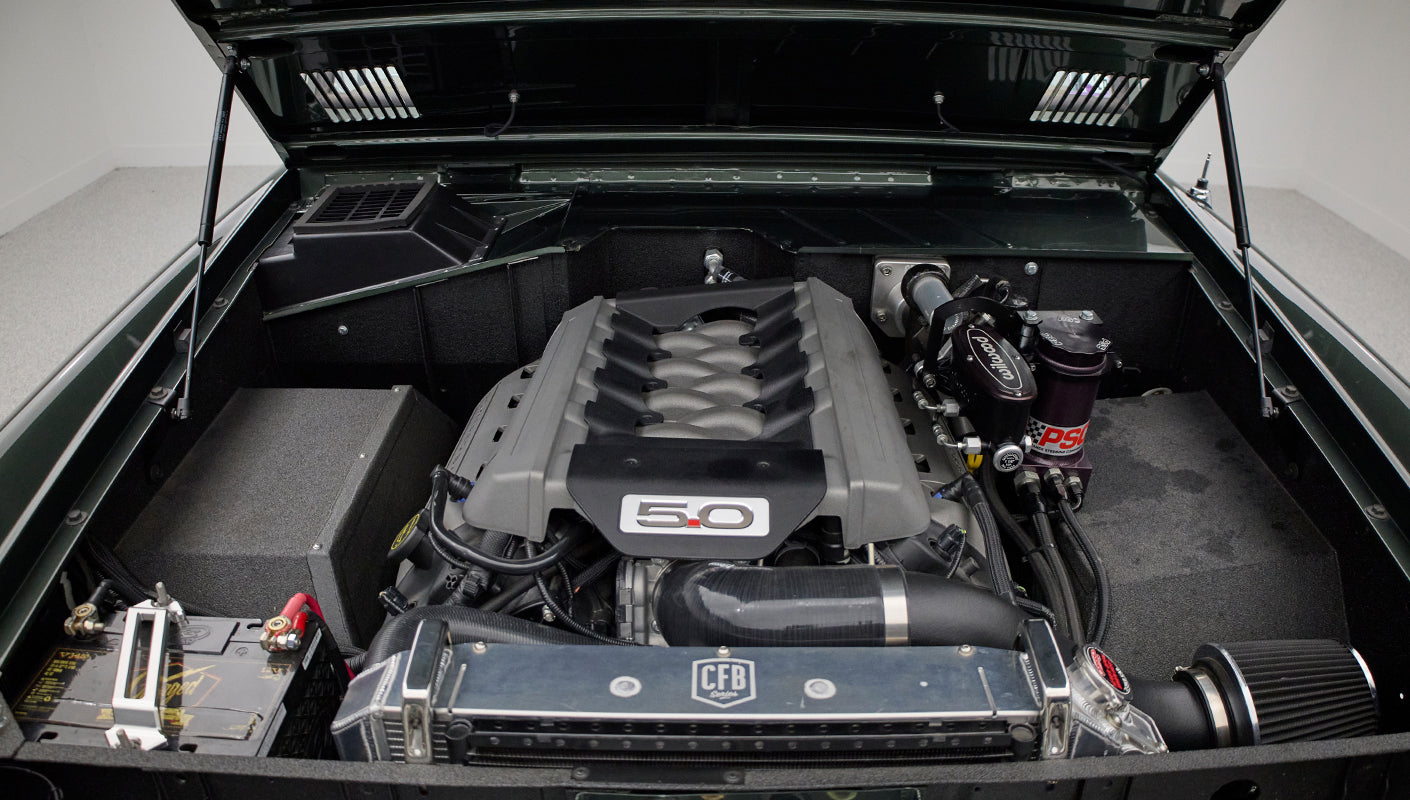Close-up view of engine components inside Classic Ford Bronco with 5.0 badge