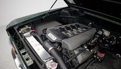 Close-up of Classic Ford Bronco engine with 5.0 liter engine cover and polished radiator