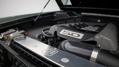 Side view of Classic Ford Bronco engine bay featuring 5.0 emblem and air intake hose