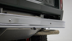 Close-up of rear bumper and exhaust pipe with backup camera on Classic Ford Bronco