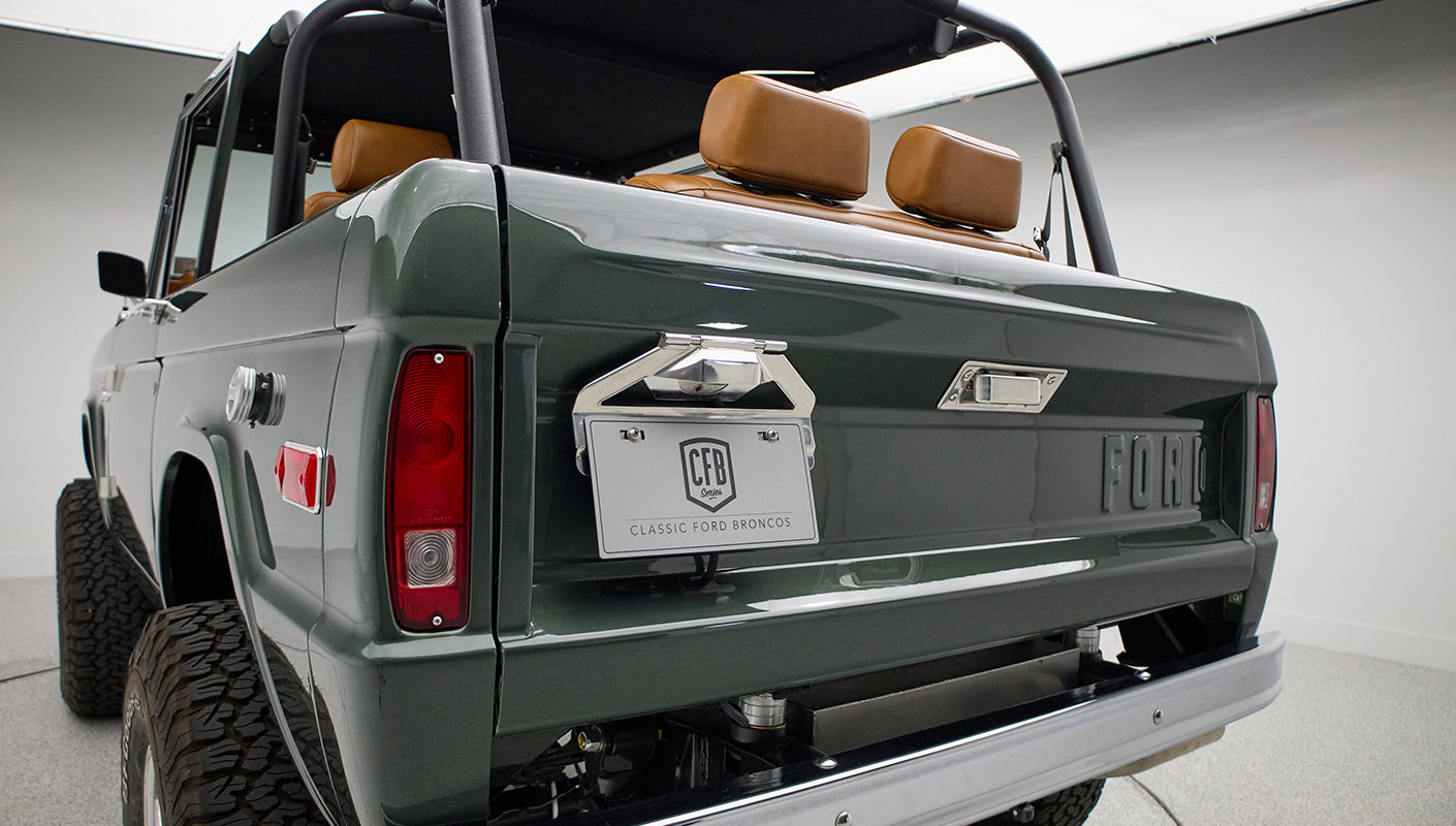 Rear view showing Classic Ford Bronco license plate and raised suspension tires