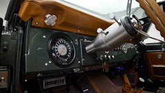 Dashboard with speedometer, air vents, and steering column of Classic Ford Bronco