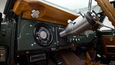 Dashboard with speedometer, air vents, and steering column of Classic Ford Bronco