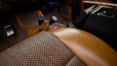 Close-up of brown leather and woven fabric seat cushion inside Classic Ford Bronco