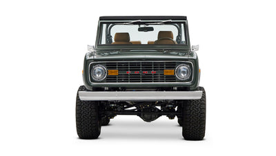 Classic Ford Bronco dark green front view with chrome bumper, grill, and amber turn signals.