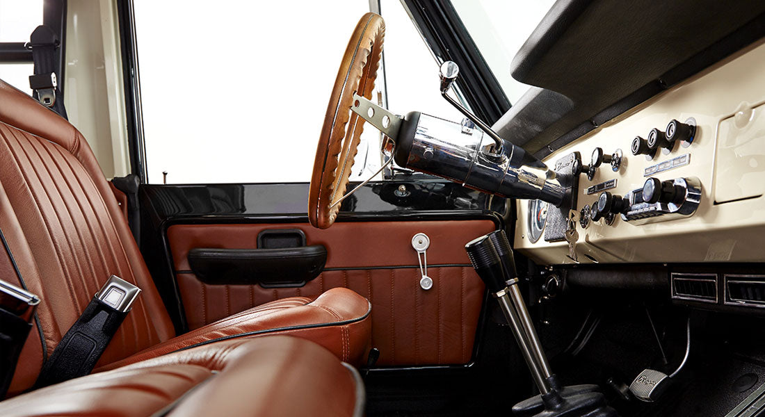 Brown leather front driver seat and dashboard interior of Classic Ford Bronco