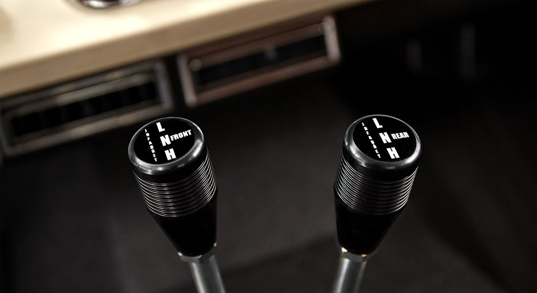 Close-up view of gearshift and transfer case levers inside Classic Ford Bronco