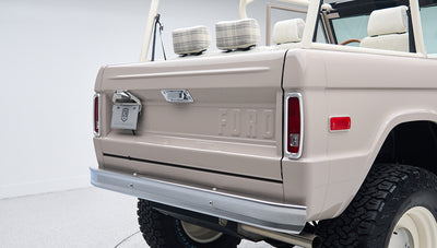 Rear corner close-up of Classic Ford Bronco in dove gray focusing on tailgate and bumper