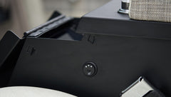 Black control knob on side panel near plaid upholstery inside classic Ford Bronco