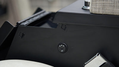 Black control knob on side panel near plaid upholstery inside classic Ford Bronco