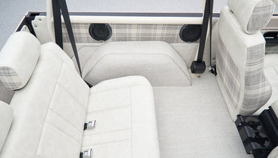 Rear seating area of Classic Ford Bronco with light upholstery and built-in speakers