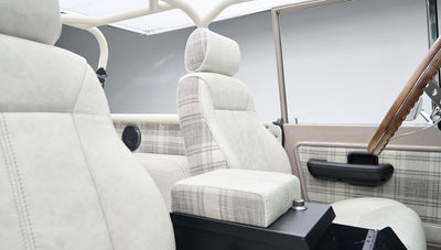 Front seats and interior side door of Classic Ford Bronco with plaid fabric accents