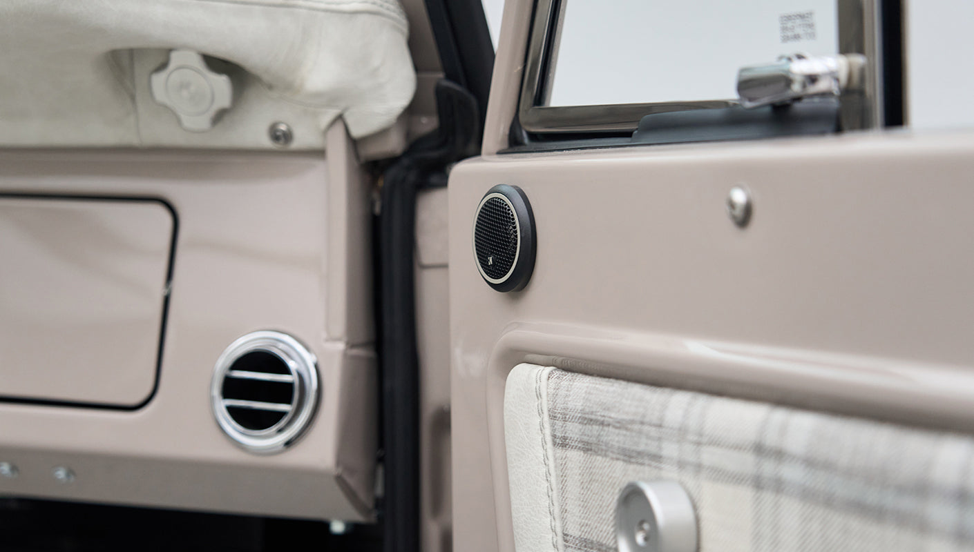 Close-up of entertainment speaker and air vent on door panel of Classic Ford Bronco