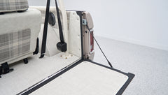 Rear cargo area of Classic Ford Bronco with open tailgate and light upholstery
