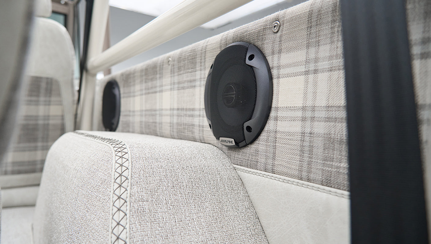Close-up of Alpine speaker and plaid interior detail in Classic Ford Bronco